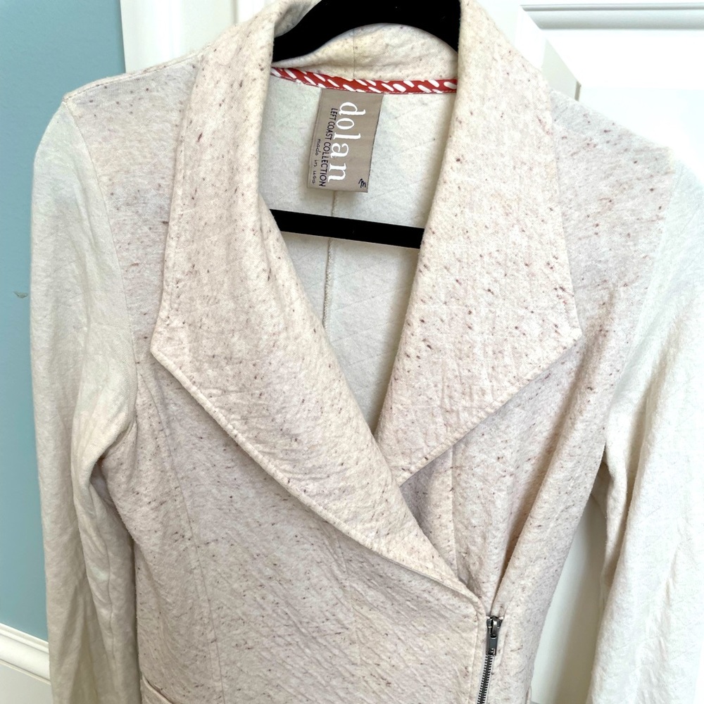 Cream jacket that has slight peplum back